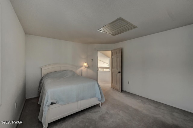 bedroom featuring carpet floors and a textured ceiling