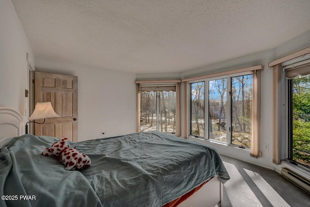 bedroom featuring a baseboard radiator, carpet flooring, access to outside, and a textured ceiling