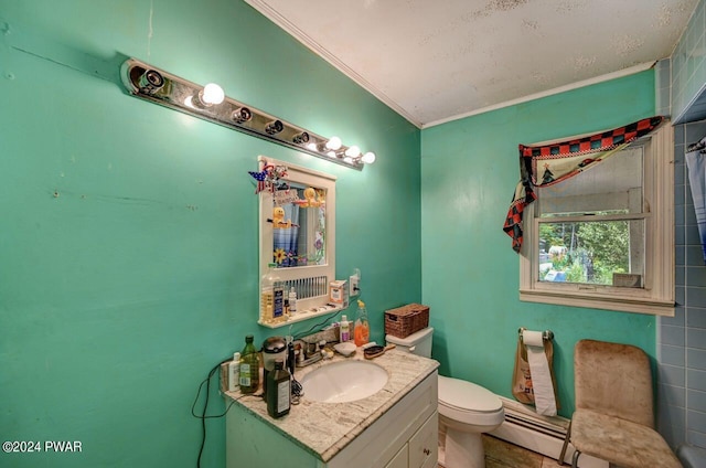 bathroom with vanity, toilet, baseboard heating, and ornamental molding