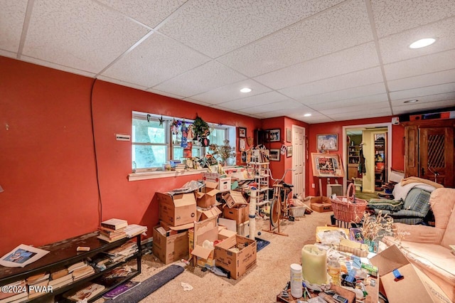 misc room featuring a paneled ceiling and carpet