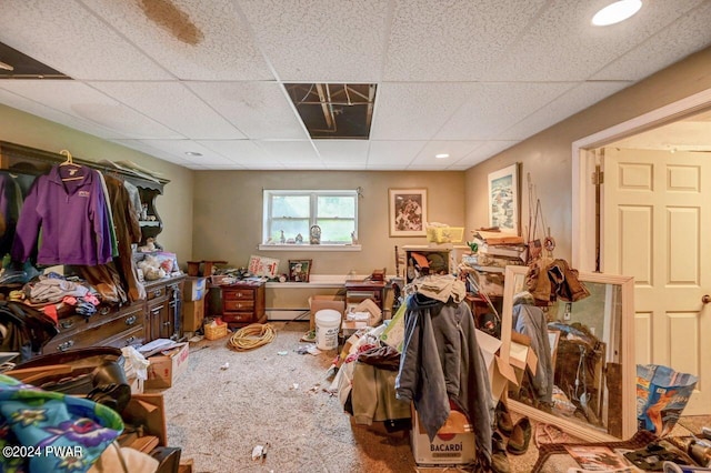 misc room featuring baseboard heating and a drop ceiling