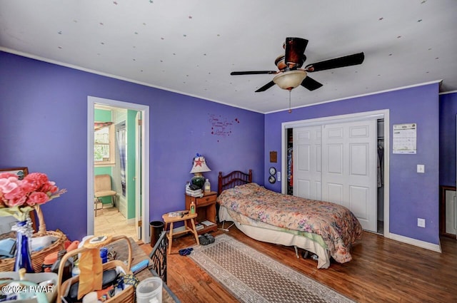 bedroom with ceiling fan, wood-type flooring, ensuite bathroom, and a closet