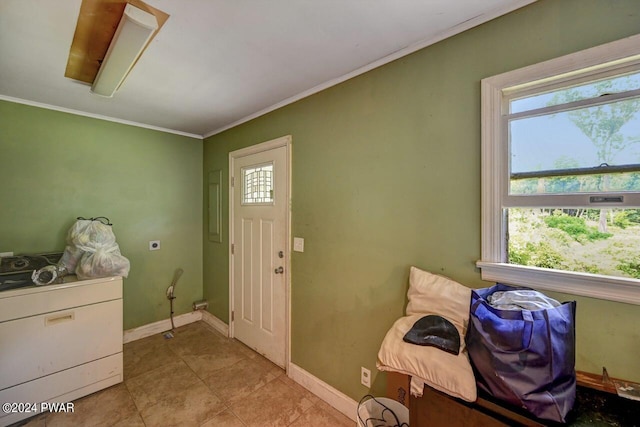 foyer entrance featuring crown molding and light tile patterned floors