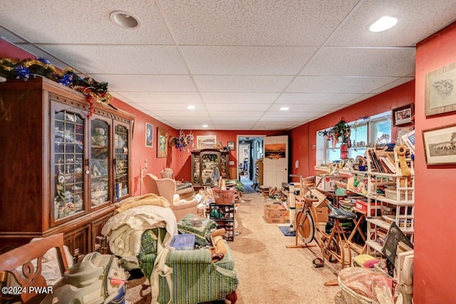 interior space featuring a paneled ceiling and carpet floors