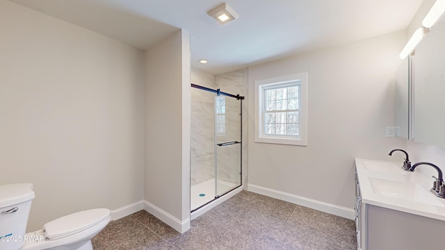 bathroom with vanity, an enclosed shower, and toilet