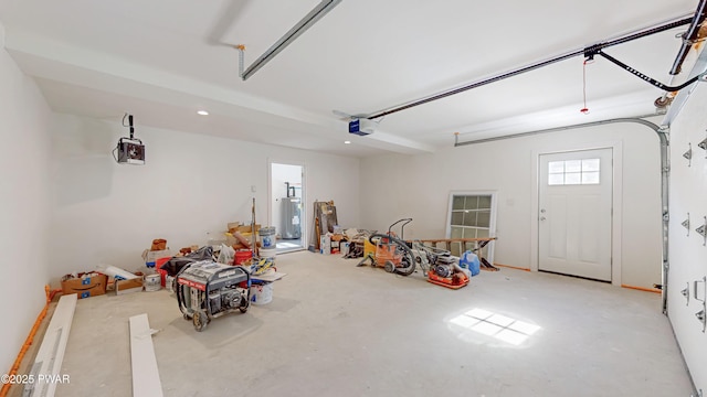 garage with water heater and a garage door opener