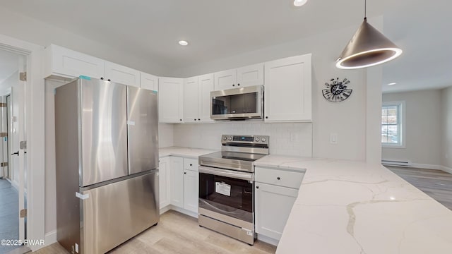 kitchen featuring white cabinetry, a baseboard radiator, pendant lighting, stainless steel appliances, and light stone countertops