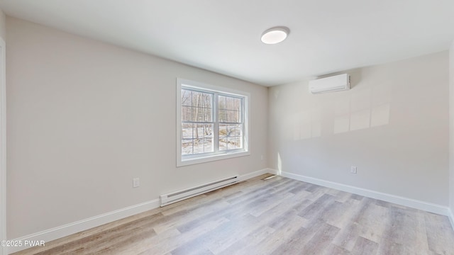 spare room with a baseboard radiator, a wall mounted AC, and light wood-type flooring