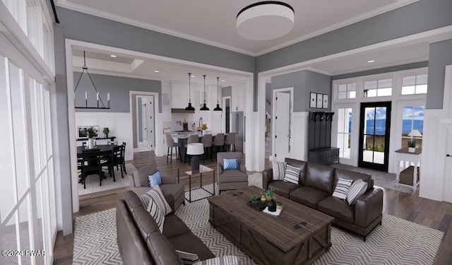 living room with wood-type flooring, ornamental molding, and a chandelier