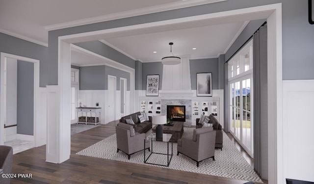 living room featuring hardwood / wood-style floors, ornamental molding, and a tiled fireplace