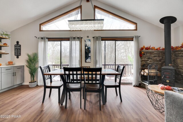 2894 S Fairway Dr, Lake Ariel, PA 18436 - dining room with a wood stove, an inviting chandelier, light wood-type flooring, and lofted ceiling