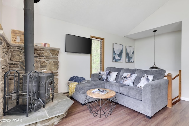 2894 S Fairway Dr, Lake Ariel, PA 18436 - living room featuring vaulted ceiling, a wood stove, baseboards, and wood finished floors