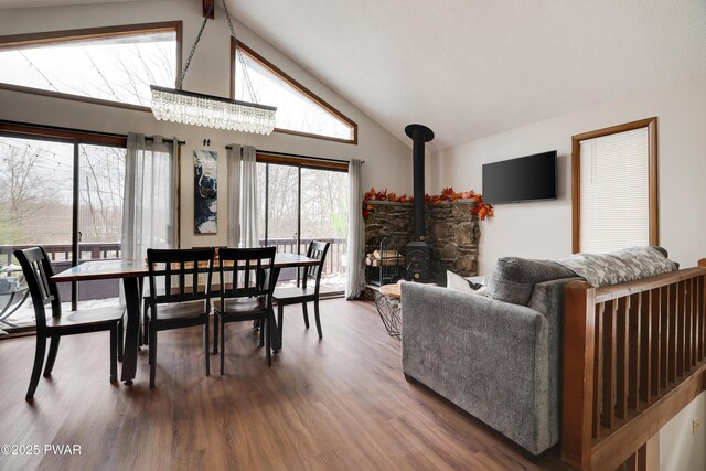 2894 S Fairway Dr, Lake Ariel, PA 18436 - dining area with a wood stove, wood finished floors, and high vaulted ceiling