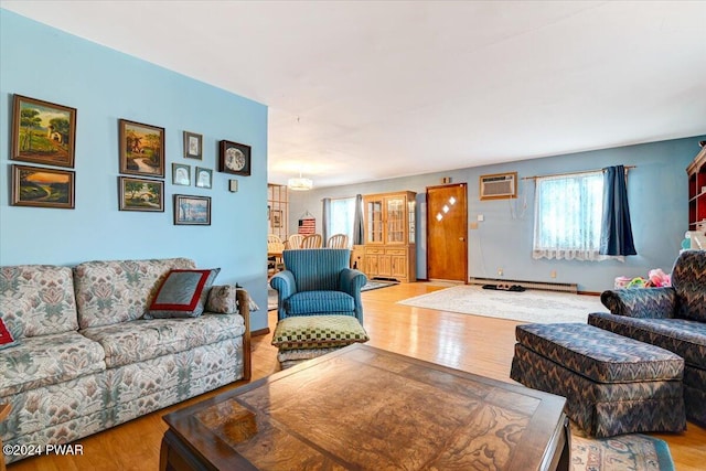 living room featuring a wall mounted air conditioner, light wood-type flooring, and a baseboard radiator