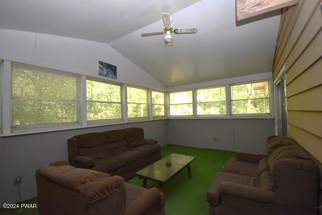 sunroom / solarium featuring ceiling fan, plenty of natural light, and vaulted ceiling