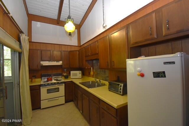 kitchen featuring sink and white appliances