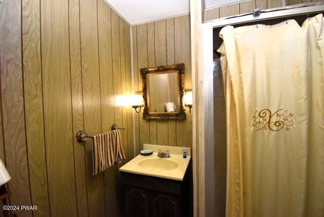 bathroom with wooden walls and vanity