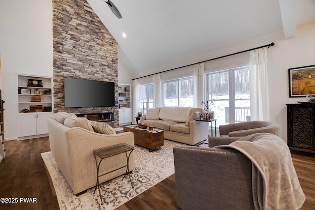 living room featuring dark wood-type flooring, a fireplace, and high vaulted ceiling