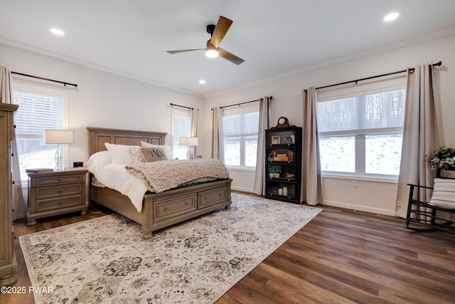 bedroom with baseboards, dark wood-style flooring, crown molding, and recessed lighting