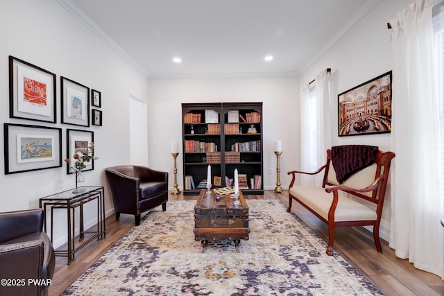 sitting room featuring baseboards, ornamental molding, wood finished floors, and recessed lighting