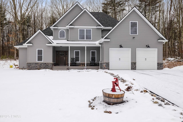 view of front of property with an outdoor fire pit, stone siding, covered porch, and an attached garage