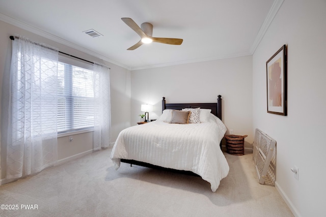 bedroom with baseboards, ornamental molding, visible vents, and light colored carpet