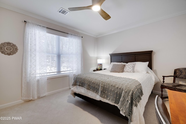 bedroom featuring ceiling fan, visible vents, baseboards, carpet, and crown molding