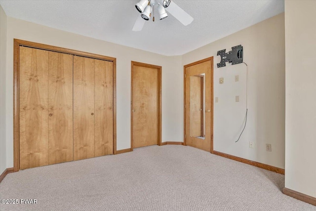 105 Beechwood Ln, Greentown, PA 18426 - unfurnished bedroom featuring carpet, a textured ceiling, a ceiling fan, multiple closets, and baseboards