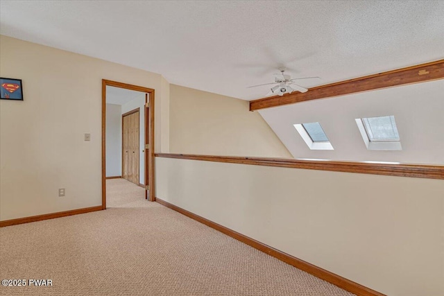 105 Beechwood Ln, Greentown, PA 18426 - hall featuring carpet, a textured ceiling, baseboards, and lofted ceiling with skylight