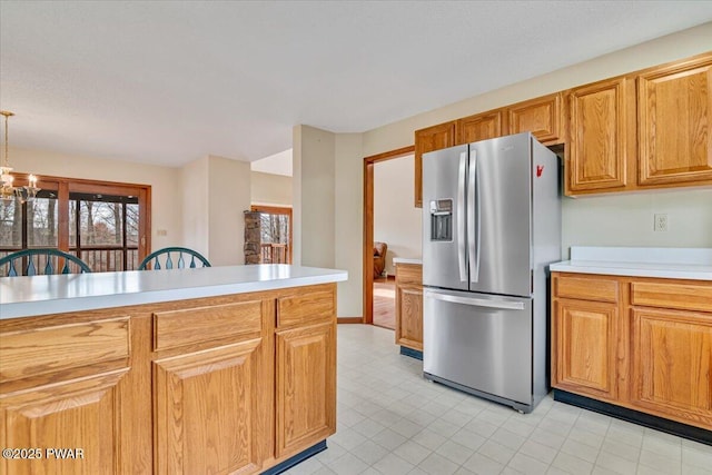 105 Beechwood Ln, Greentown, PA 18426 - kitchen featuring stainless steel fridge, decorative light fixtures, a notable chandelier, light countertops, and brown cabinets