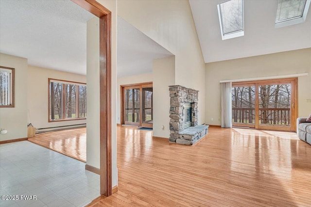 105 Beechwood Ln, Greentown, PA 18426 - living area with a baseboard radiator, high vaulted ceiling, baseboards, and plenty of natural light