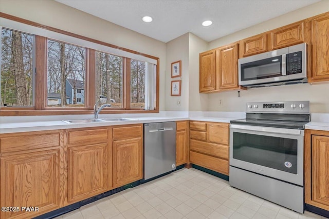 105 Beechwood Ln, Greentown, PA 18426 - kitchen with a sink, light countertops, appliances with stainless steel finishes, brown cabinets, and recessed lighting