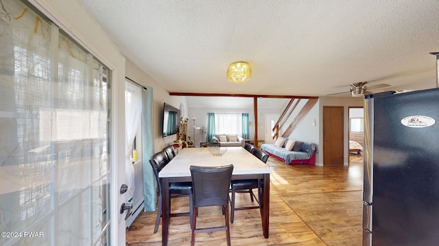 dining space with ceiling fan and a textured ceiling