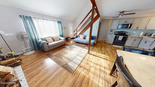 living room featuring light wood-type flooring, ceiling fan, and lofted ceiling