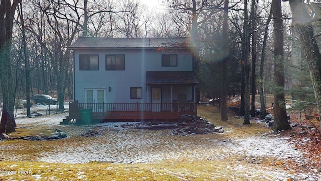 rear view of house with french doors and a wooden deck