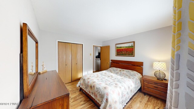 bedroom with light wood-type flooring and a closet