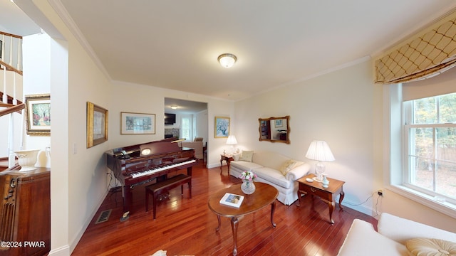 living room with wood-type flooring and crown molding