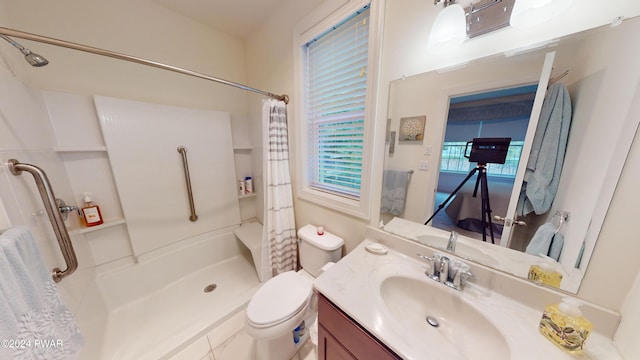 bathroom featuring vanity, toilet, and walk in shower