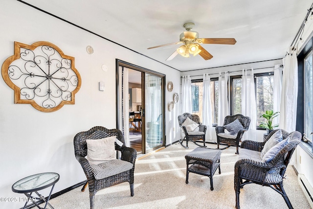 interior space featuring ceiling fan and a baseboard heating unit