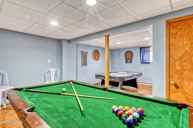 recreation room featuring hardwood / wood-style floors, pool table, and a baseboard heating unit