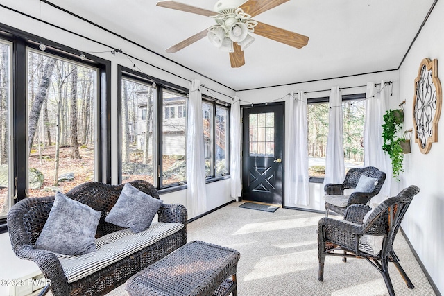 sunroom / solarium featuring ceiling fan