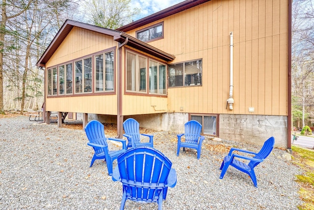 rear view of house featuring a sunroom