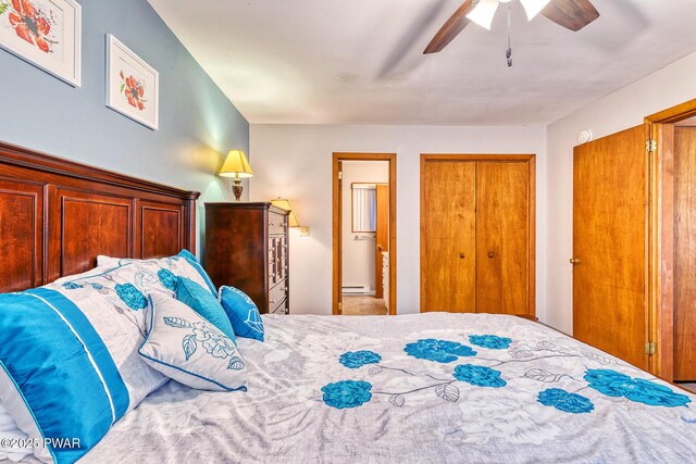 bedroom with ceiling fan and a baseboard radiator