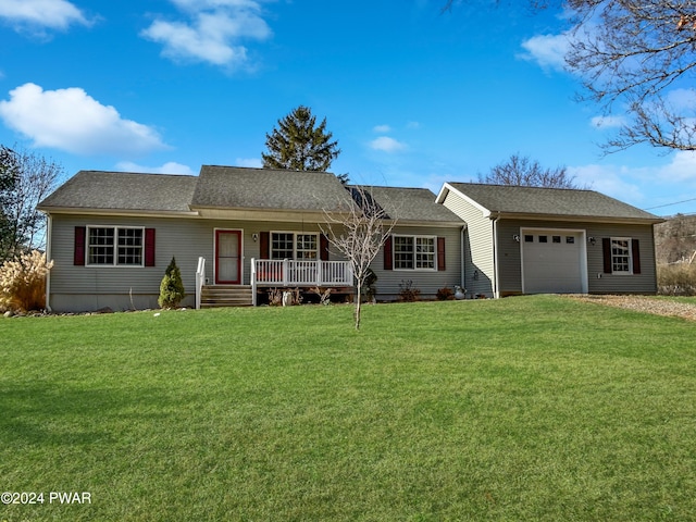 single story home with a porch, a garage, and a front yard