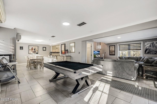 recreation room with billiards, ornamental molding, and an AC wall unit