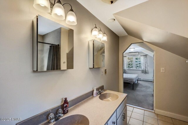 2557 Long Pond Rd, Long Pond, PA 18334 - full bathroom featuring a baseboard radiator, tile patterned floors, double vanity, lofted ceiling, and baseboards