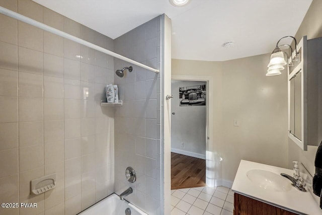 bathroom with vanity, tiled shower / bath combo, and tile patterned floors