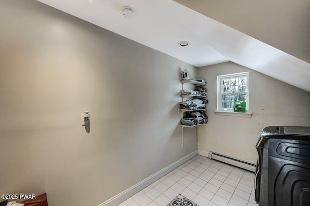 washroom featuring washer / clothes dryer, light tile patterned flooring, and baseboard heating