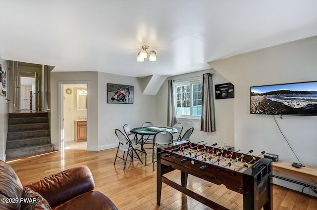 playroom featuring baseboard heating and light hardwood / wood-style flooring