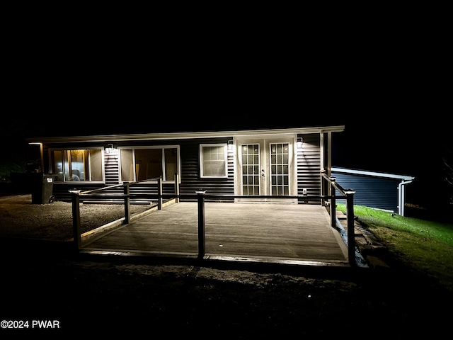 view of front of house with a wooden deck and french doors